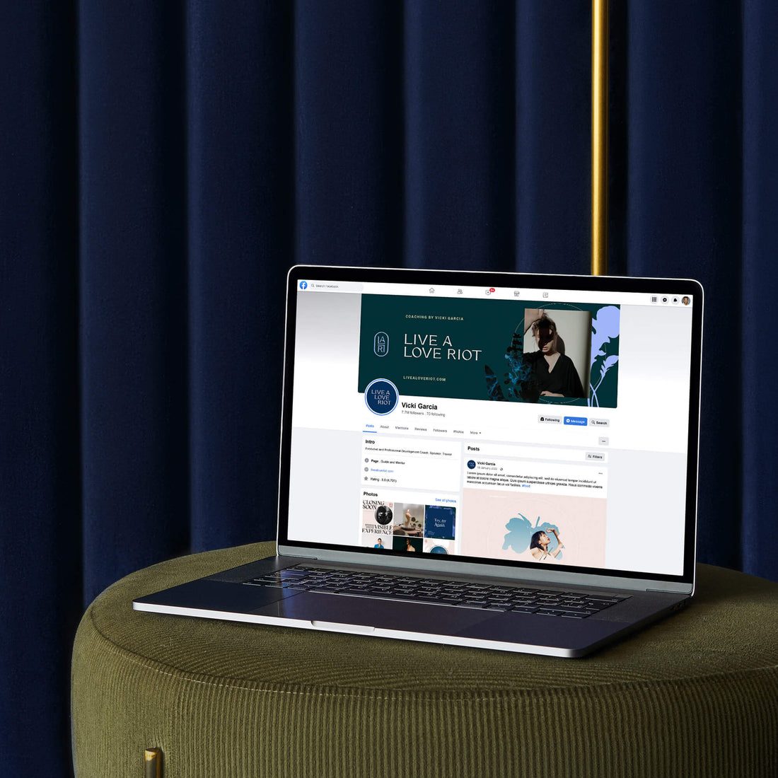 Brand designer portfolio image of the Live A Love Riot Facebook page. A macbook sits in front of a blue curtain and shows the elegant brand photography combining with custom logo design.