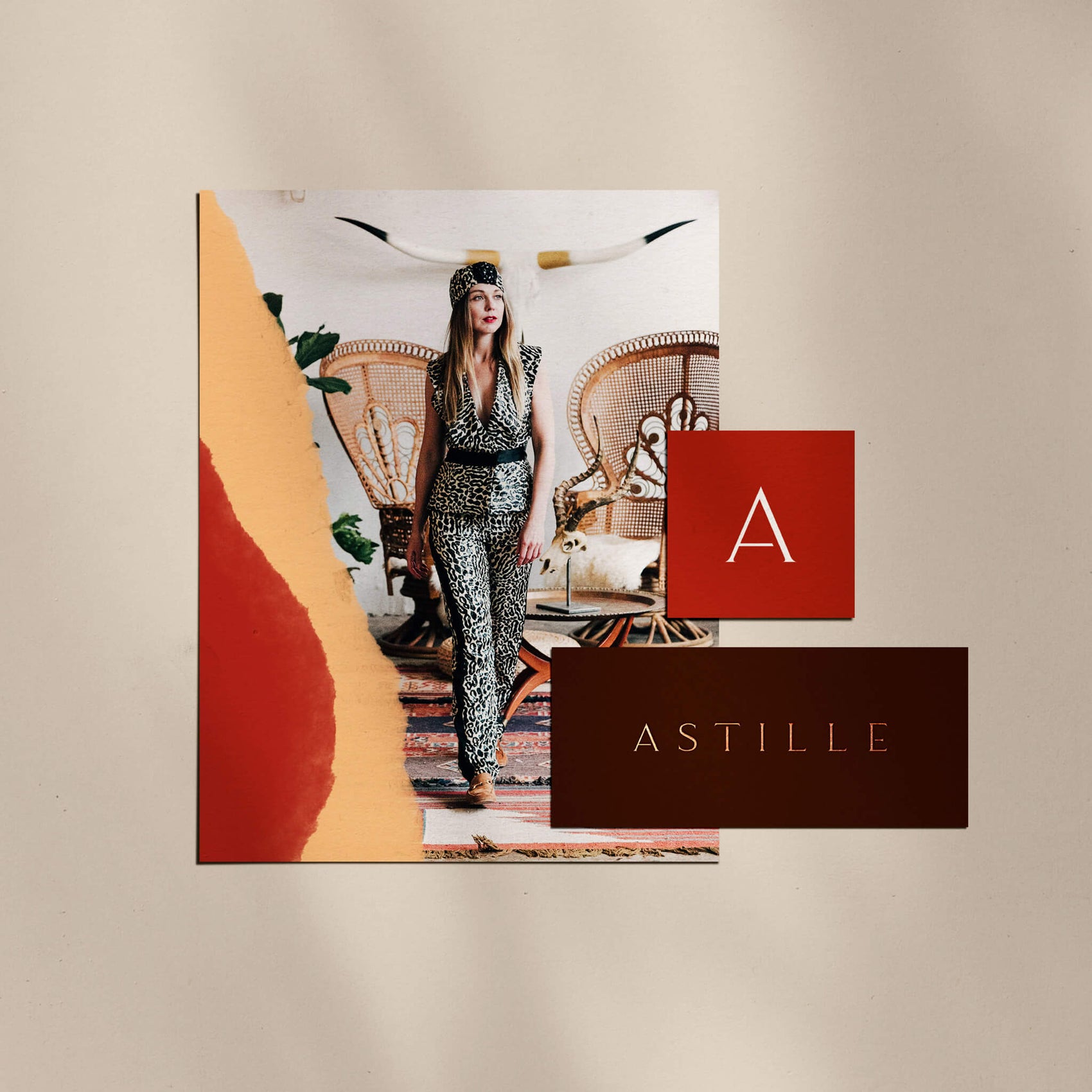 Fashion branding case study image of the Astille collateral. On a beige background sits a card with a model in the clothing, a square red card with the ‘a’ icon and a brown card with copper foiling of the full ‘Astille’ logo. 