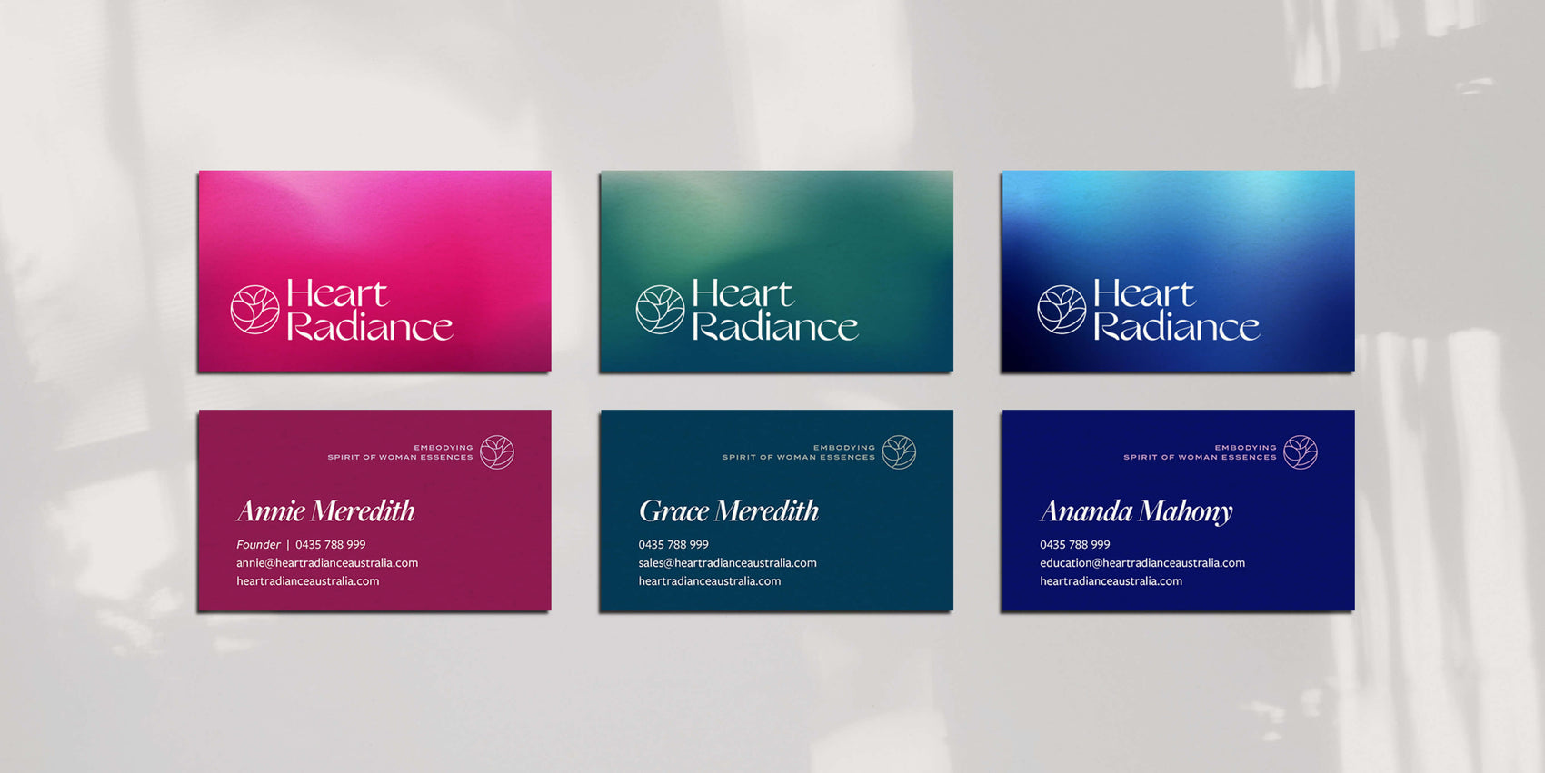 Rebranding case study image of the HeartRadiance custom business cards. Each card features the logo on one side and details on the other- each with a different of the brand gradients. 