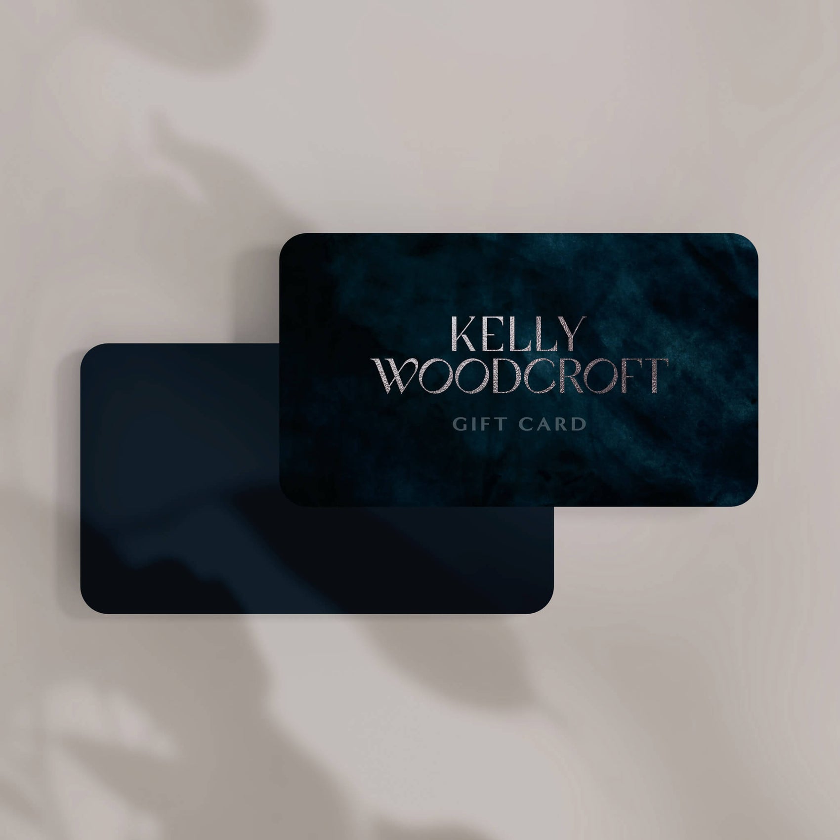 Fashion brand design inspiration image of the Kelly Woodcroft digital gift card. A silver foil texture makes the logotype stand out from the crushed velvet background image. 
