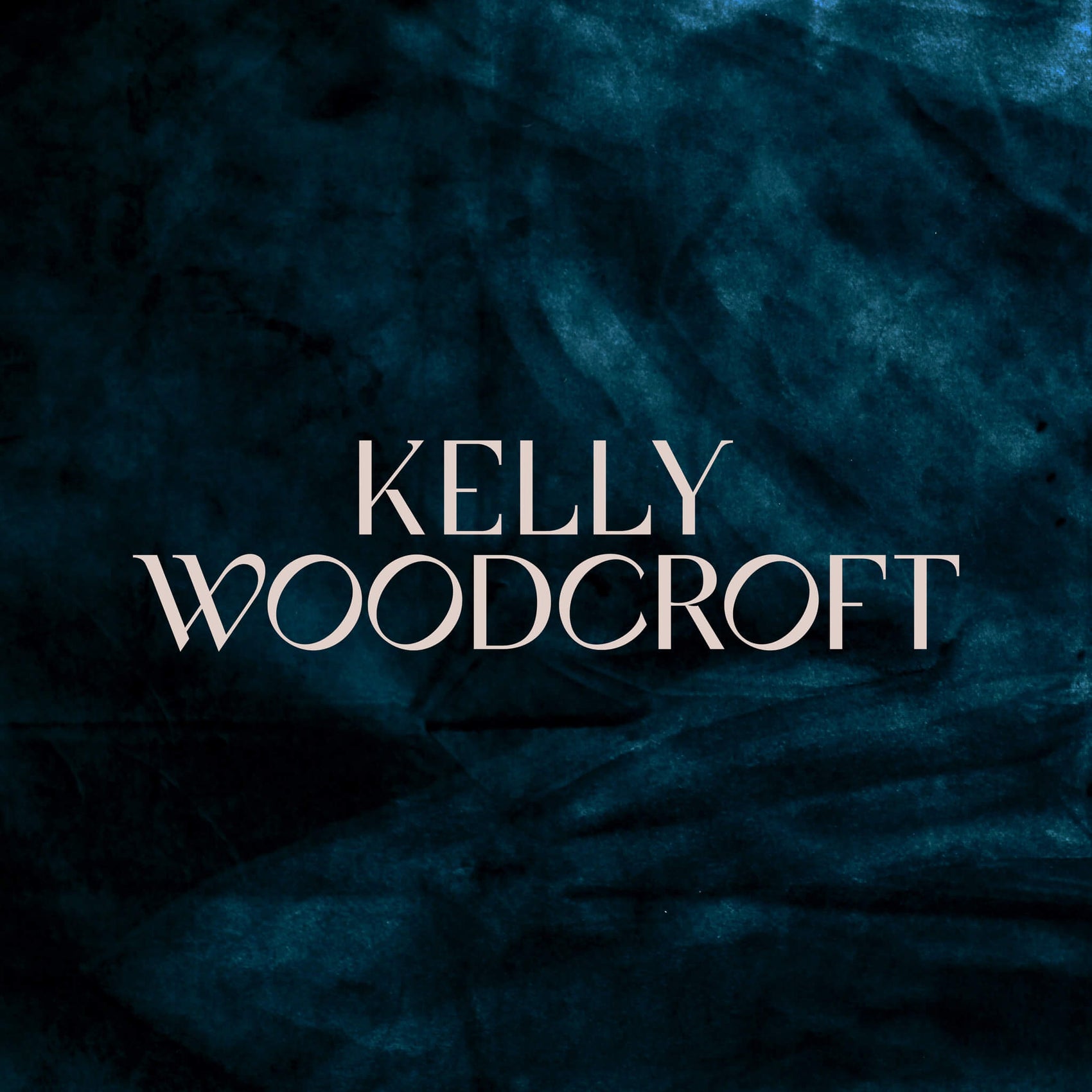 The custom jewellery designer logo for Kelly Woodcroft is in white on a shadowy teal velvet background. The elegant typography feels high end but still with personality.