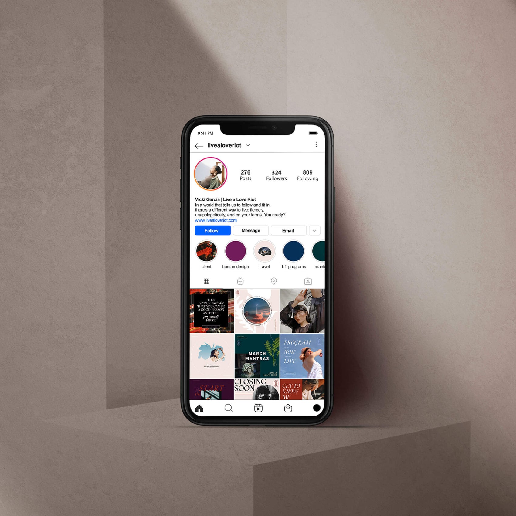 Brand designer portfolio image of the Live A Love Riot instagram feed. An iphone sits in a cream setting and shows the bold colour and photography approach in the brand. 