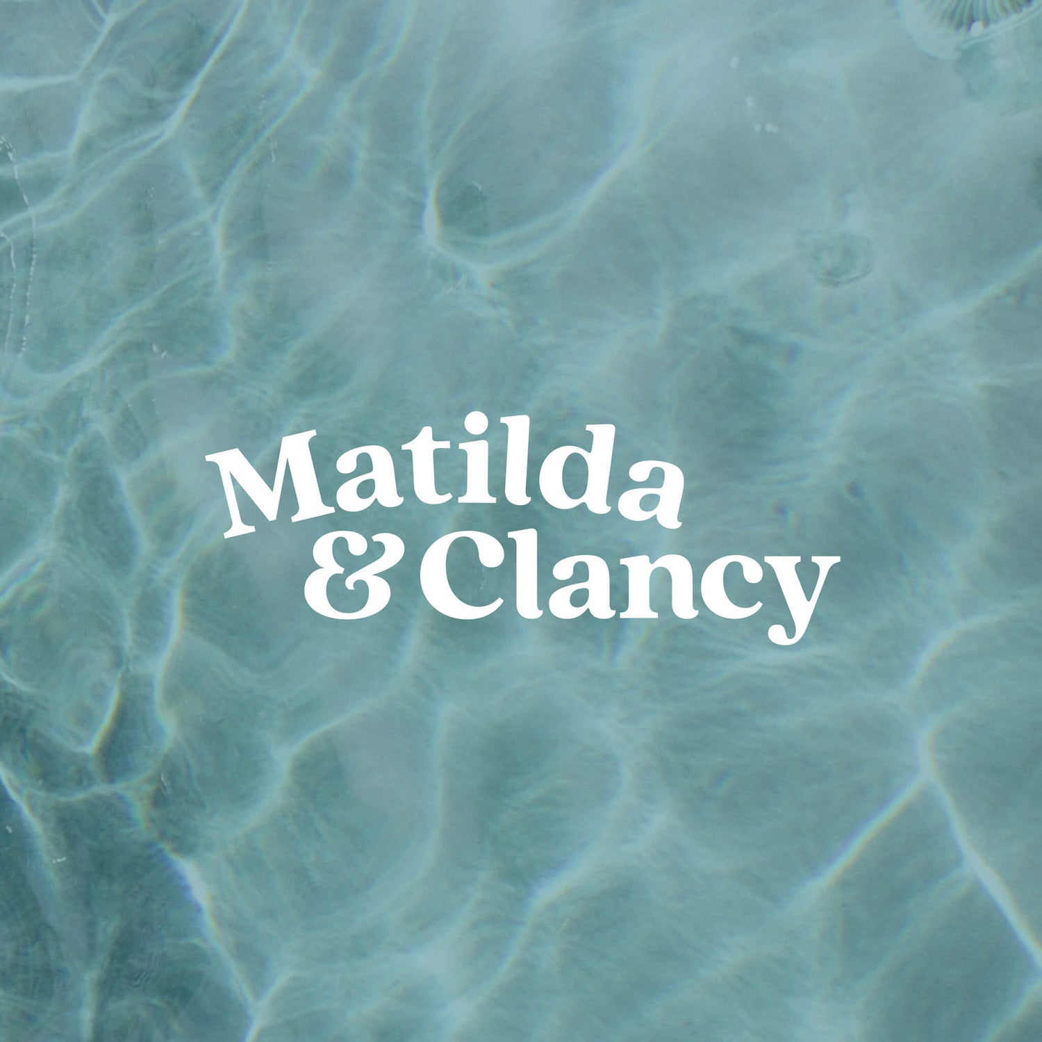 Childrens fashion designer logo image shows the Matilda & Clancy logotype. On a watery background of a pool, the chunky serif logo type sits in white. 