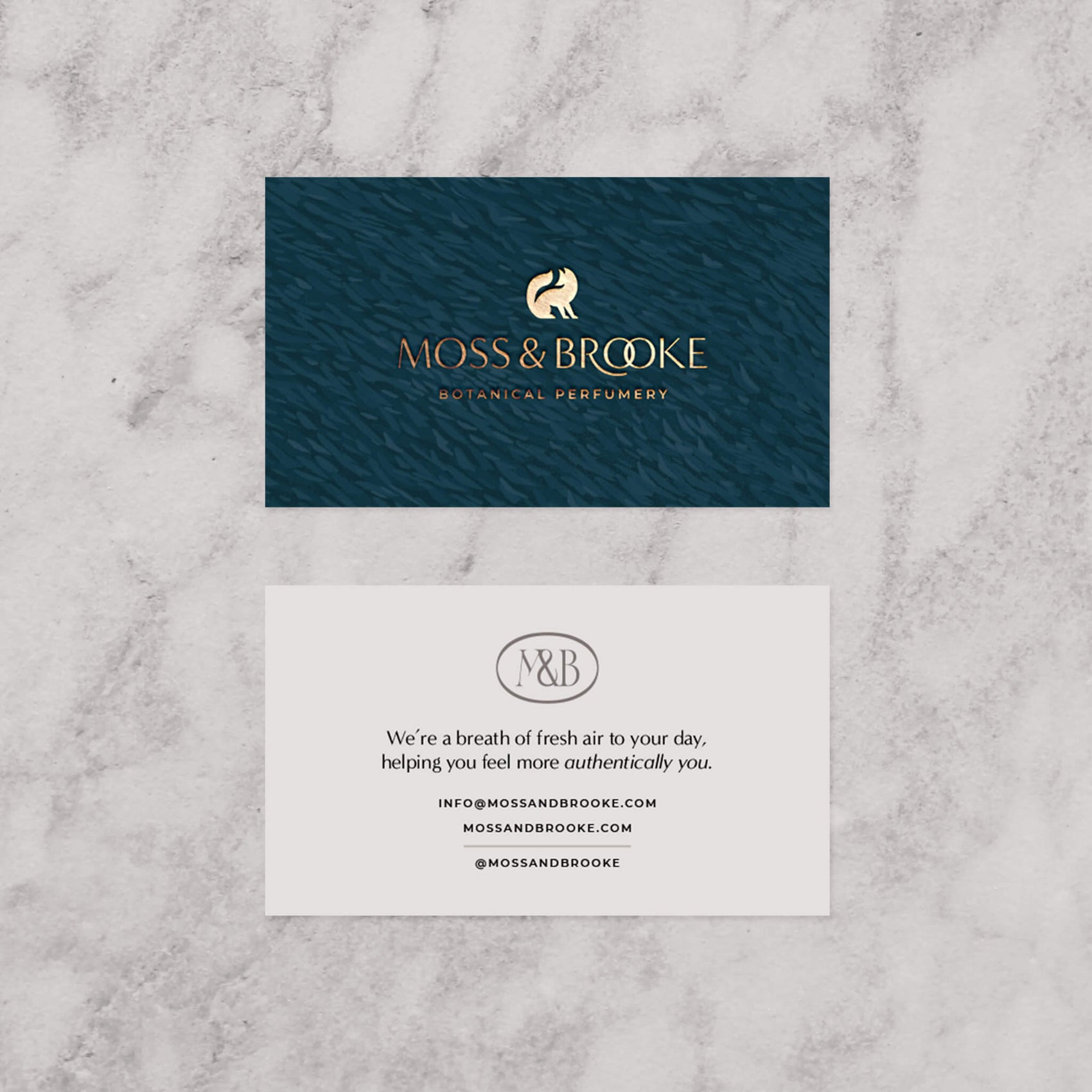 Rebranding case study image of the Moss & Brooke branded custom business cards. Featuring a linocut brand texture and gold foil detailing, the custom cards are timeless and elegant. 