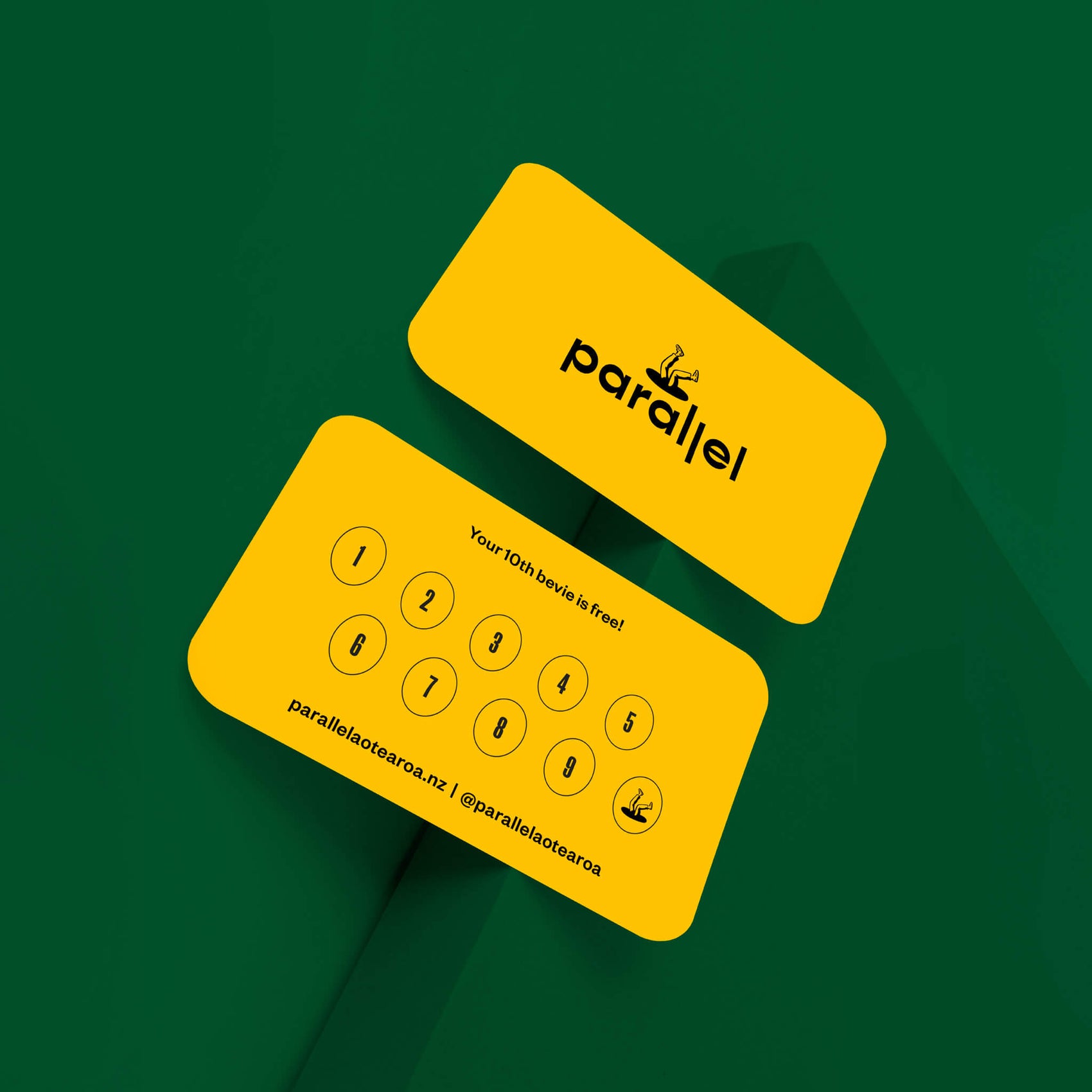 Coffee house brand identity case study for Parallel shows a coffee loyalty card in a green background. Printed on bold yellow stock, the front features a logo while the back has a stamp section to mark off.