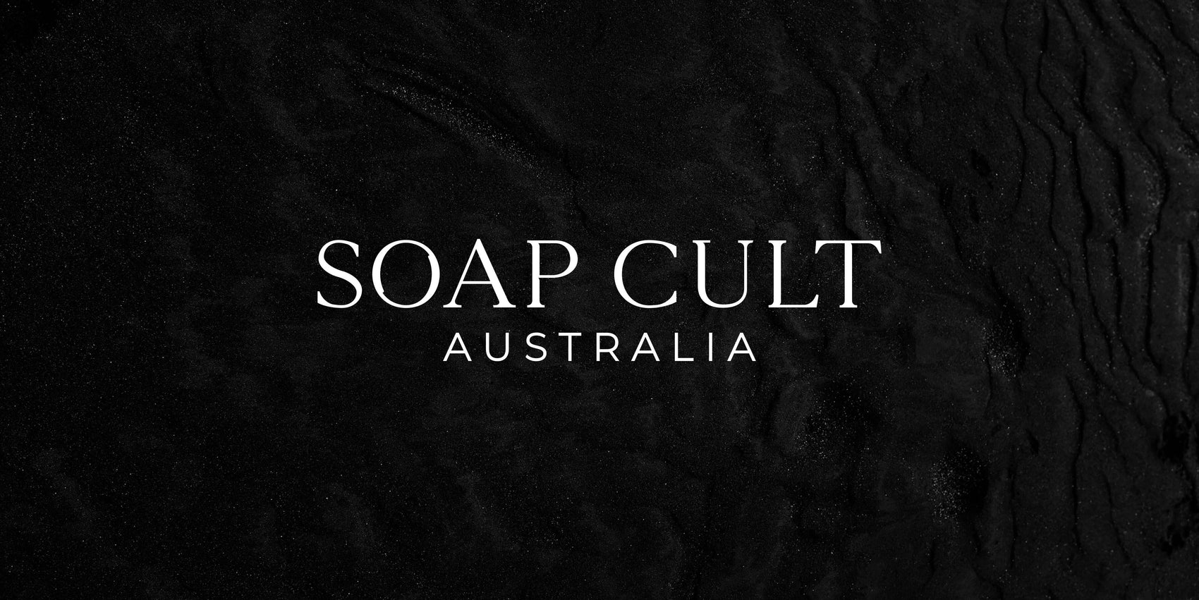 Soap brand design portfolio image of the Soap Cult Australia logo in white on a black textured background. The letterforms feature elegant serifs for a high end feel.