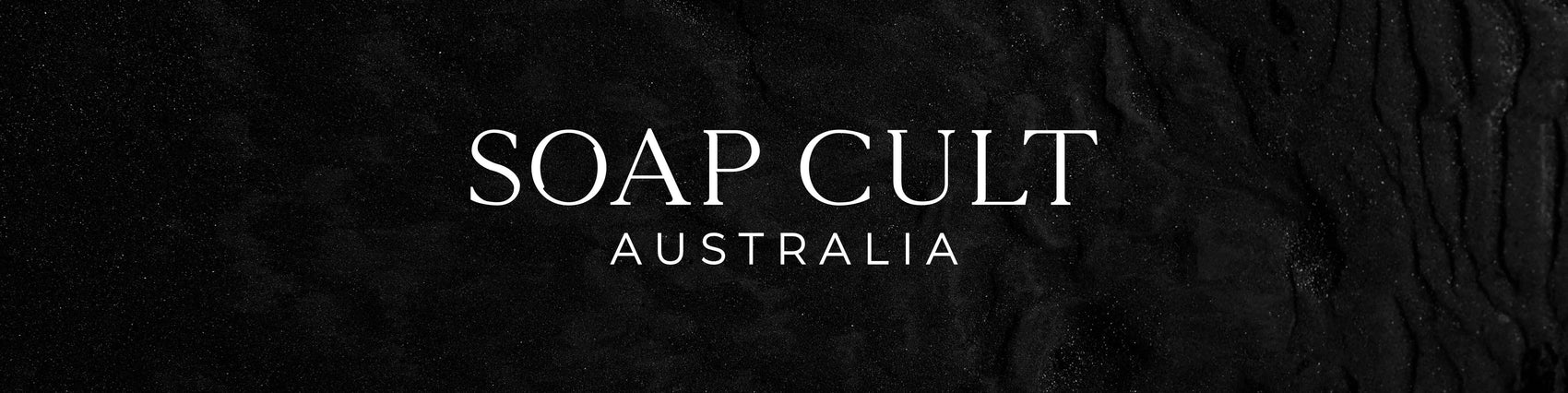 Brand design portfolio image of the Soap Cult Australia custom logo in white on a black textured background. The custom letterforms feature elegant serifs for a high end feel.