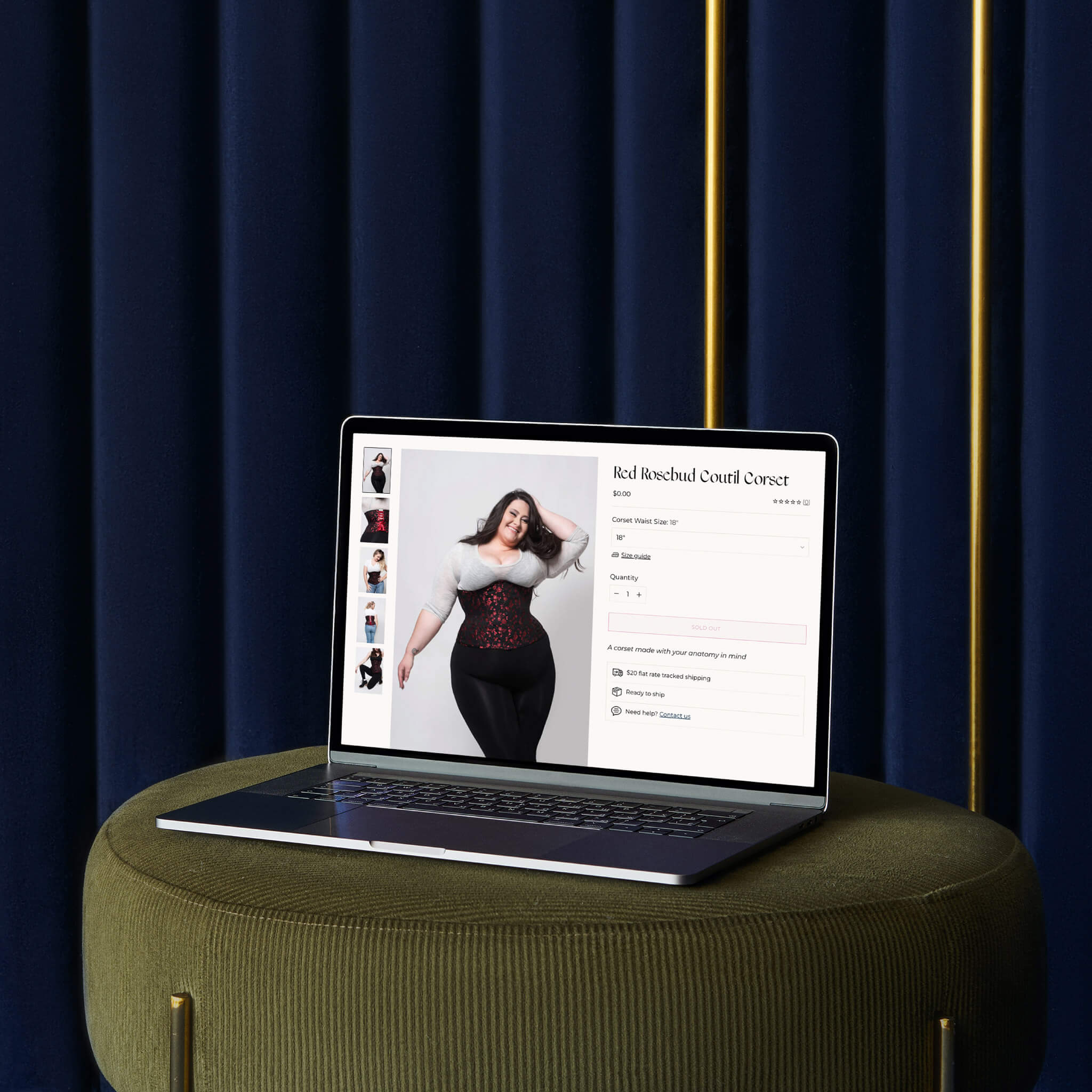 Brand identity case study image of The Bad Button’s product page of their Shopify website. The desktop image shows the standard corset product layout on a macbook laptop on a green velvet stool in front of deep blue curtains.