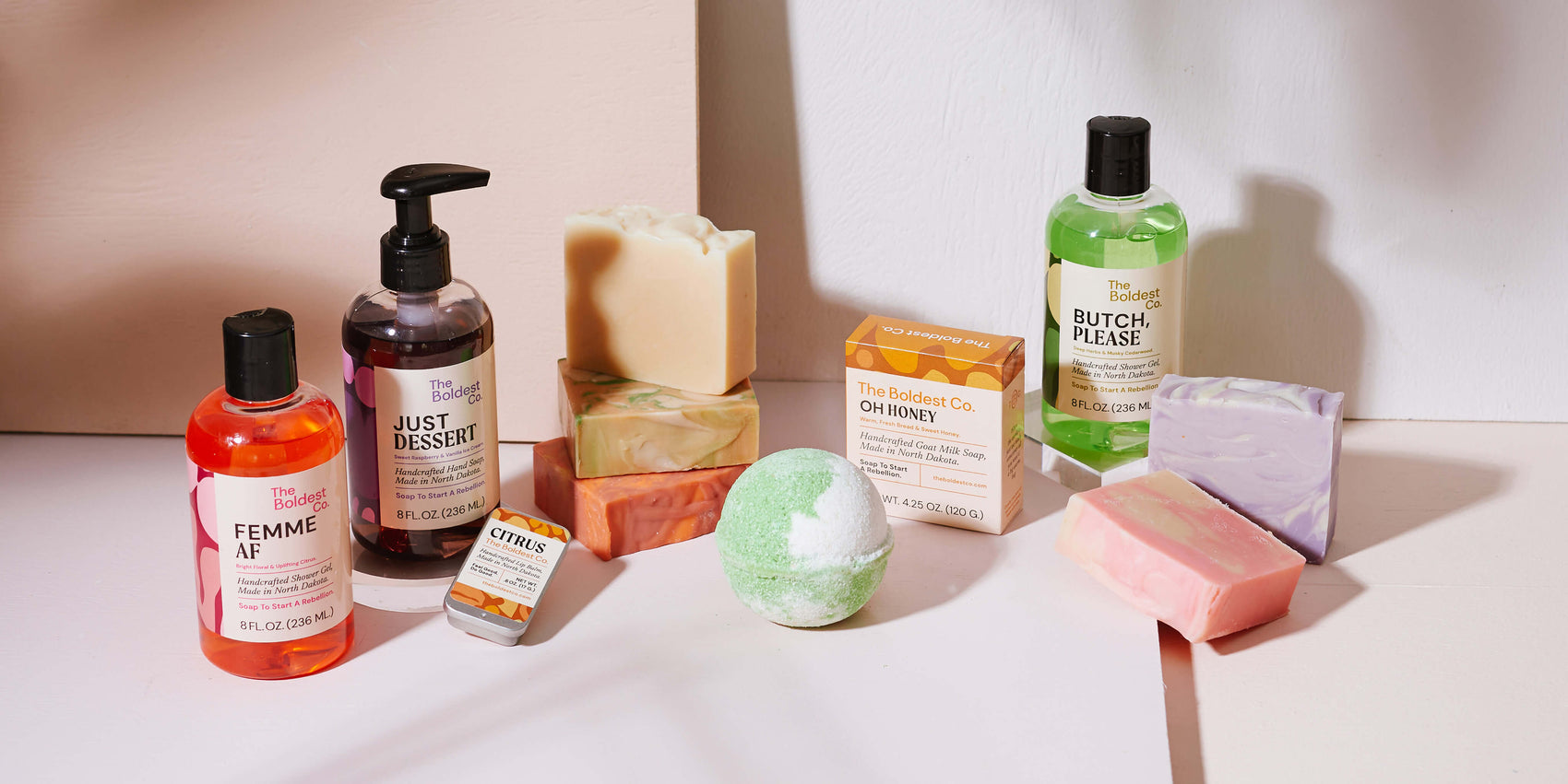 Handmade soap brand identity case studyBrand identity case study image of The Boldest Co’s wholesale PDF document. Arranged in a cream coloured background, the colourful product packaging shines and complements the colours of the products.