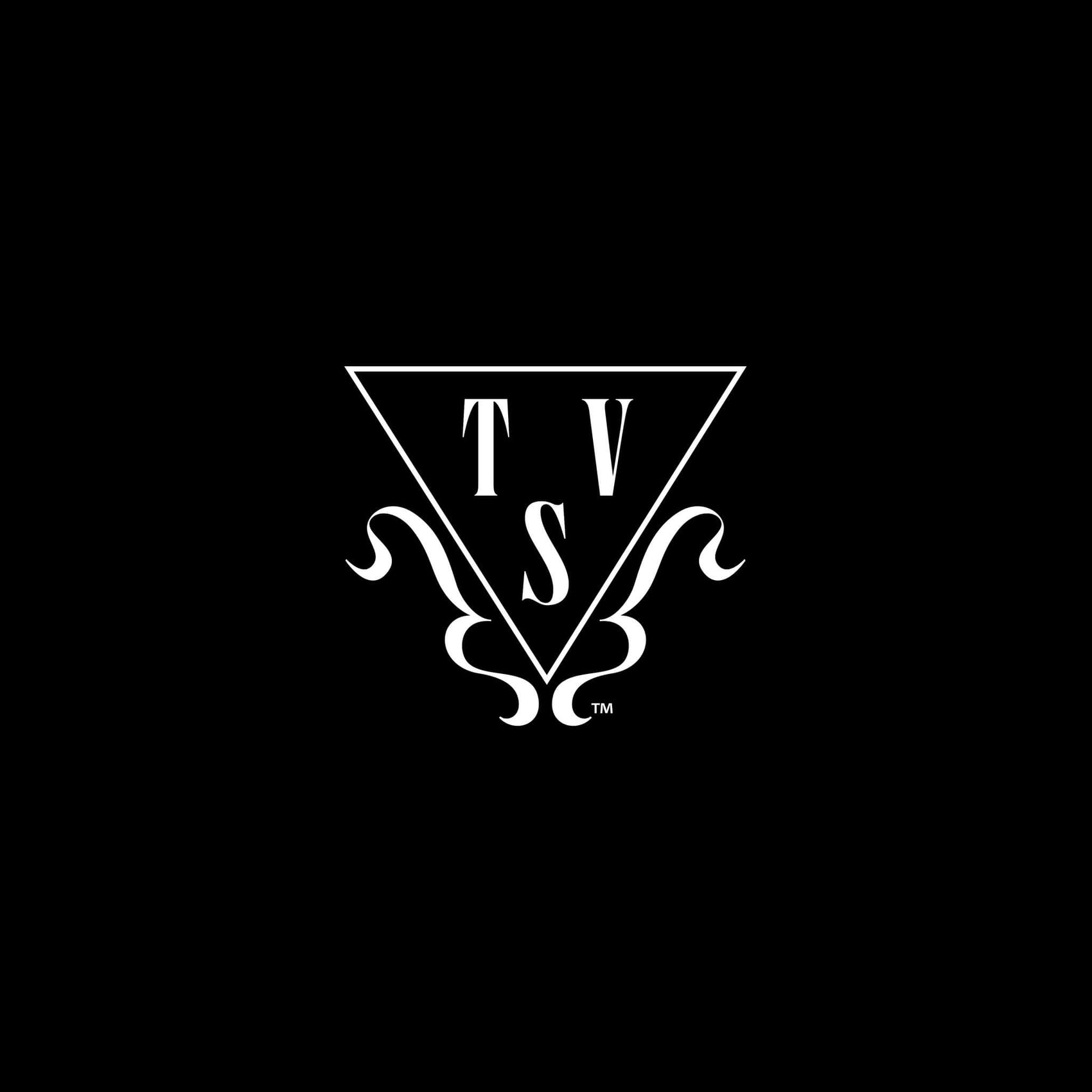 Photographer rebranding case study image of The Vixen Society brand icon. On a black background appears The Vixen Society primary icon- a 'T', 'V' and 'S' in a triangle with flourishes.