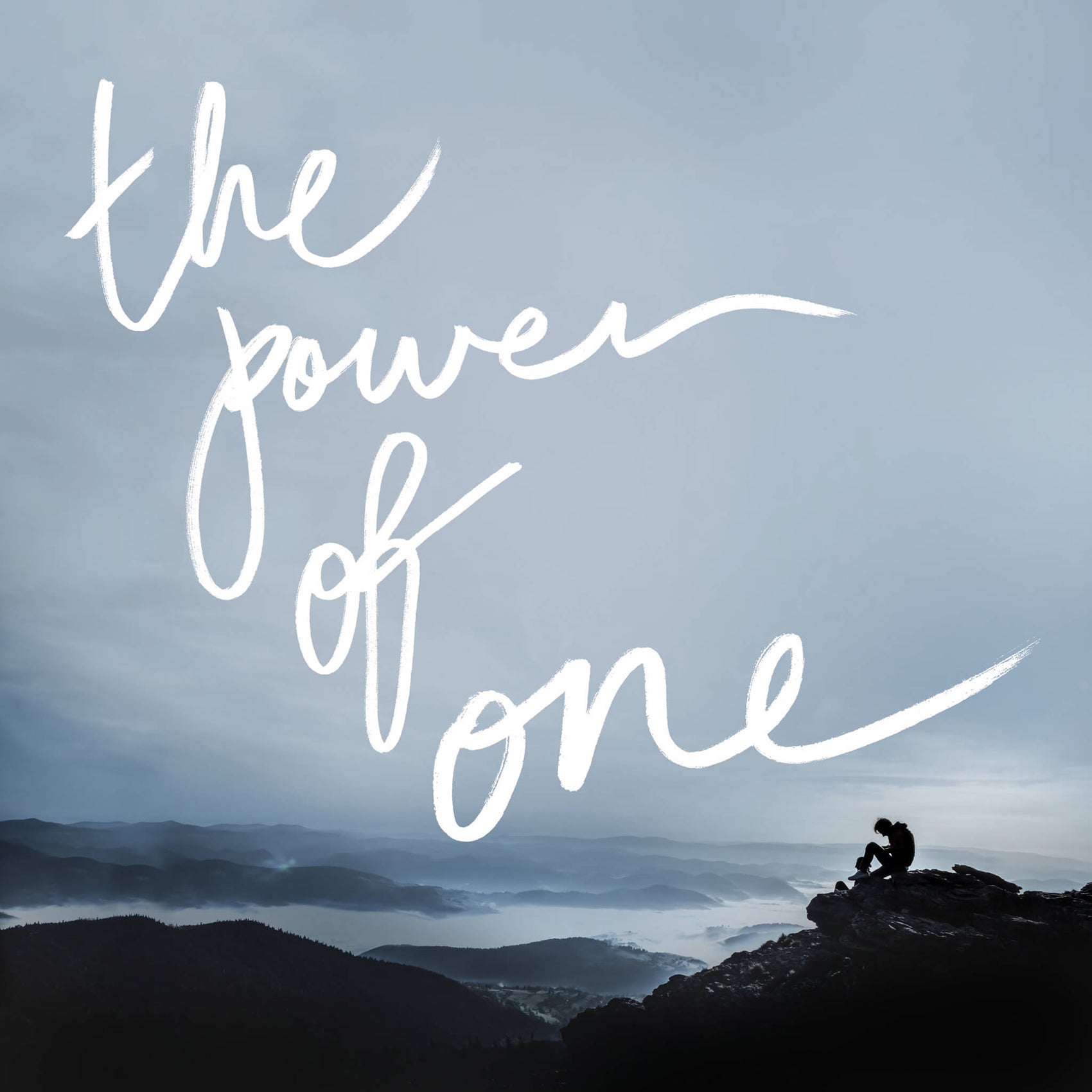 Sustainable retailer branding design case study image for ethical store Biome. On an image of a man at the top of a mountain, the phrase ‘the power of one’ is hand lettered in white. 